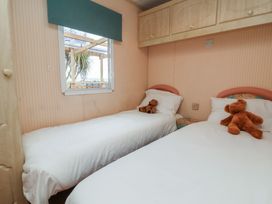 A bedroom with two beds and teddy bears at Big Bertha by the Sea in Northam