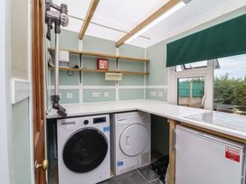 A laundry room with washing machine and tumble dryer at Big Bertha by the Sea in Northam