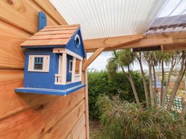 A birdhouse mounted on a wooden structure at Big Bertha by the Sea in Northam