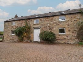 A stone house with a gravel path at Honeymug in Branton near Powburn