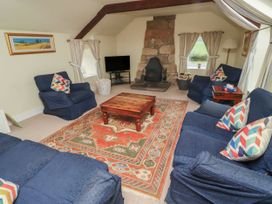 A living room with a coffee table and fireplace at Honeymug in Branton near Powburn
