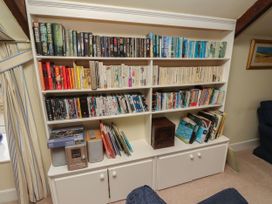 A bookshelf with books and DVDs at Honeymug in Branton near Powburn