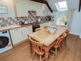A kitchen with a table and chairs at Honeymug in Branton near Powburn
