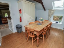 A kitchen with a dining table and chairs at Honeymug Branton near Powburn