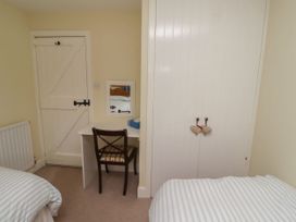 A bedroom with a desk and chair at Honeymug in Branton near Powburn