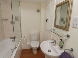A bathroom with a bathtub and shower at Honeymug in Branton near Powburn
