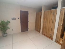 A changing room with lockers and a door at Honeymug in Branton near Powburn