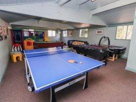 A game room with a ping pong table and foosball table at Honeymug in Branton near Powburn