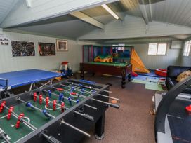 A playroom with a foosball table and a ping pong table at Honeymug in Branton near Powburn