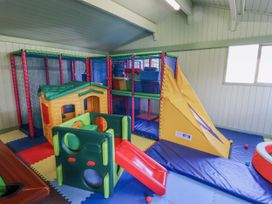 A playroom with a play structure and slide at Honeymug in Branton near Powburn