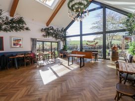 A dining room with tables and chairs at Honeymug in Branton near Powburn