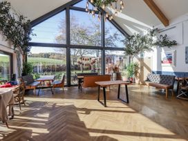 A dining room with tables and chairs at Honeymug in Branton near Powburn