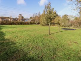 A garden with grass and a trampoline at Honeymug in Branton near Powburn