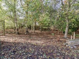 A garden area with trees and a play structure at Honeymug in Branton near Powburn