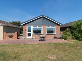 A house with a table and chairs in an outdoor area at Beach House