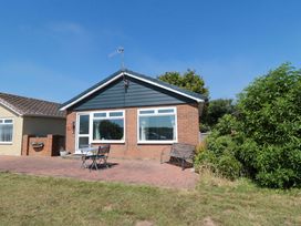 A house with a garden seating area at Beach House in 