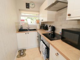 A kitchen with a sink and microwave at Beach House