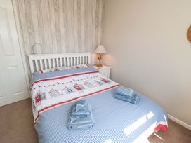 A bedroom with a bed and nightstand at Beach House
