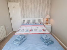 A bedroom with a bed and nightstand at Beach House