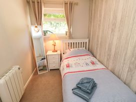A bedroom with a bed and lamp at Beach House 