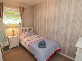A bedroom with a bed and lamp at Beach House
