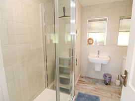 A bathroom featuring a shower, sink, and toilet at Beach House