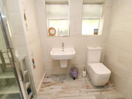 A bathroom with a sink a toilet and a shower at Beach House