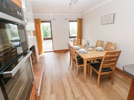 A dining room with a table and chairs at Tig Bhan in Narberth