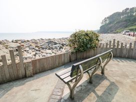 A bench overlooking stones and the sea at Tig Bhan in Narberth