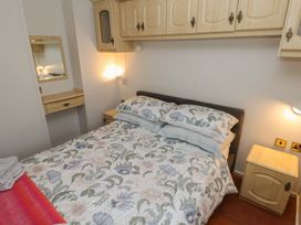 A bedroom with a bed and furniture at Static Caravan