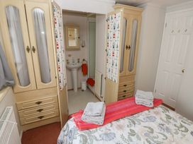 A bedroom with a bed and wardrobe at Static Caravan in 