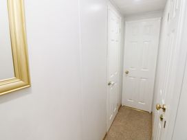 A hallway with doors and a mirror at the Static Caravan
