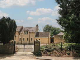 A building with a gate and trees at the Old Cottage Hospital Annexe Burford