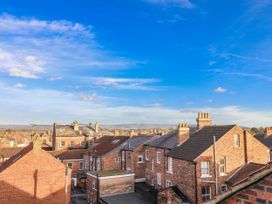 A view of rooftops and chimneys under a blue sky at 1 Castle Terrace
