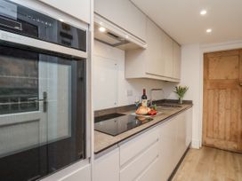 A kitchen with appliances and food items at 1 Castle Terrace in Thirsk