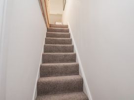 A staircase with carpet and handrail at 1 Castle Terrace in Thirsk