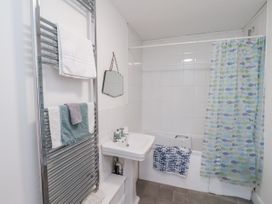 A bathroom with a sink and shower curtain at 1 Castle Terrace Thirsk