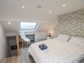 A bedroom with a bed and chair at 1 Castle Terrace in Thirsk