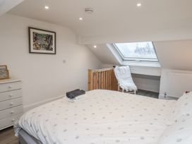 A bedroom with a bed and a dressing table at 1 Castle Terrace in Thirsk