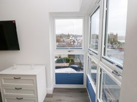 A room with a window and television at Cottage 1 in Laugharne