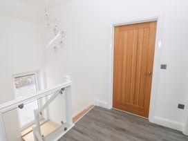 A hallway with a door and window at Cottage 1 in Laugharne