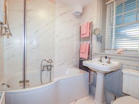 A bathroom with a bathtub, sink, and toilet at Tradewinds in Newquay