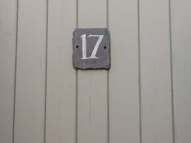 A number sign 17 on a wooden wall at Tradewinds in Newquay