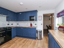 A kitchen with blue cabinets and stainless steel appliances at Aspen Boutique