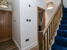 A hallway with a staircase and a door at Aspen Boutique