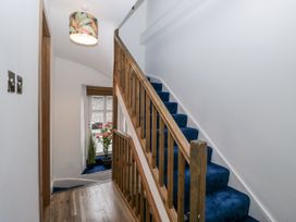 A hallway with stairs and plants at Aspen Boutique