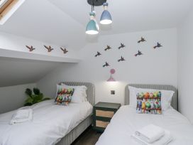 A bedroom with two beds and colorful wall art at Aspen Boutique in 