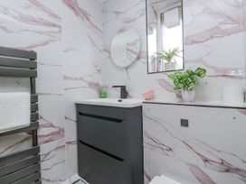 A bathroom with a sink and mirror at Aspen Boutique