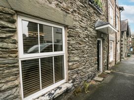 A stone building with a window and door at Aspen Boutique