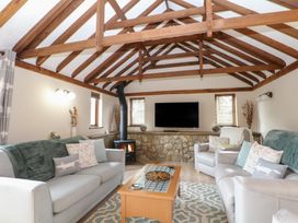 A living room with a television and fireplace at WEST LODGE in Ashford